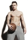 Young Male Stood Holding A Basketball